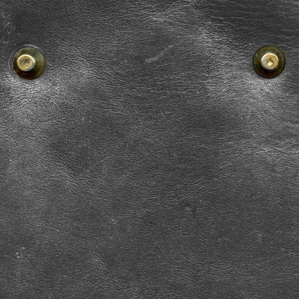 Old and scratched black leather texture, rivets — Stock Photo, Image
