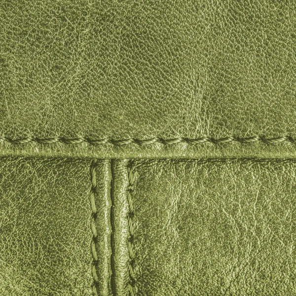 Green leather texture decorated with seams — Stock Photo, Image