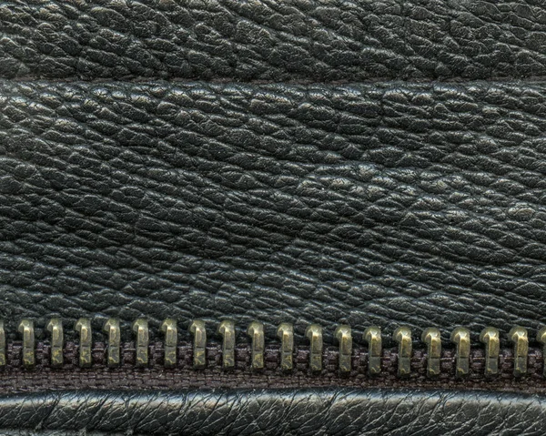 Black leather texture decorated with a zipper closeup — Stock Photo, Image