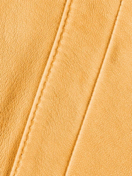 Textura de couro amarelo decorado com costuras — Fotografia de Stock