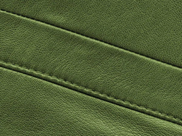 Grüne Lederstruktur mit Nähten verziert. — Stockfoto