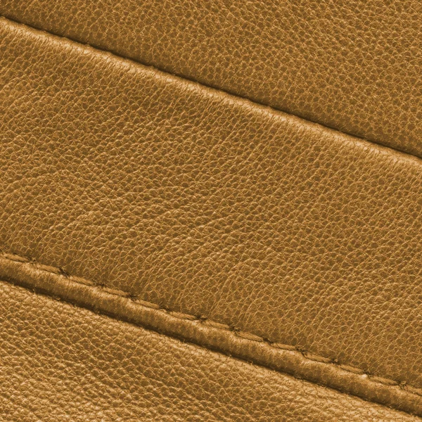 Yellow leather texture with seams closeup. — Stock Photo, Image