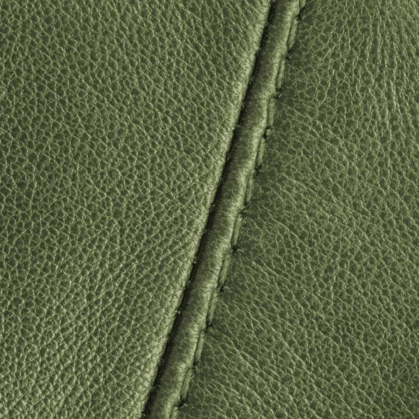 Green leather texture closeup, seam. — Stock Photo, Image