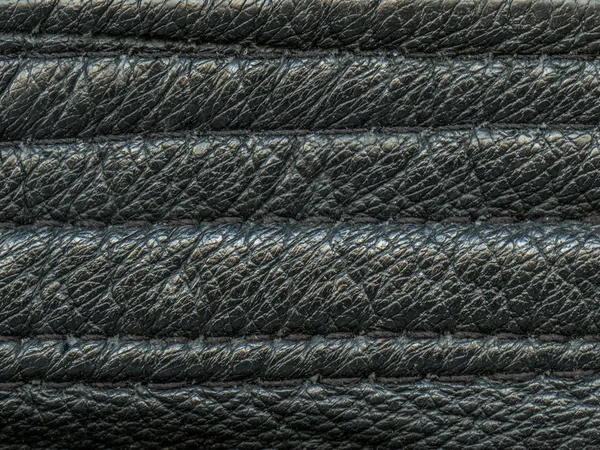 Black leather texture decorated with stitches closeup — Stock Photo, Image