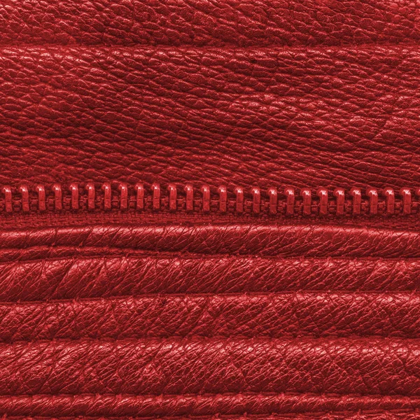 Red leather background decorated with seams and zipper — Stock Photo, Image