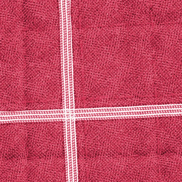 Rood textiel achtergrond close-up, witte linten, naden — Stockfoto