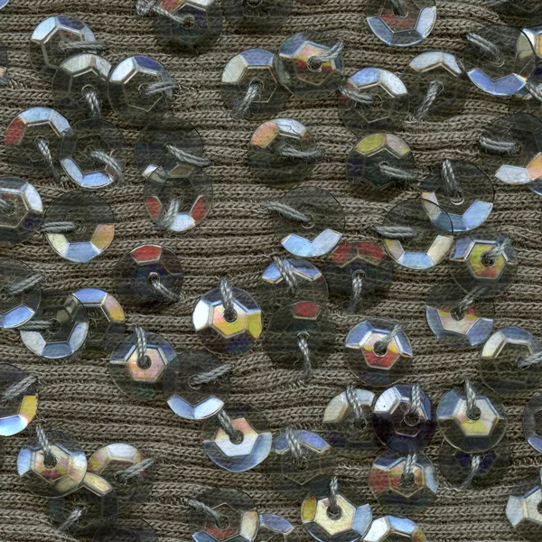Lentejuelas multicolores sobre fondo textil —  Fotos de Stock