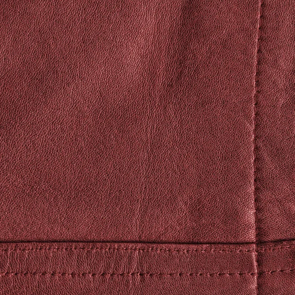 Red leather background decorated with seams — Stock Photo, Image