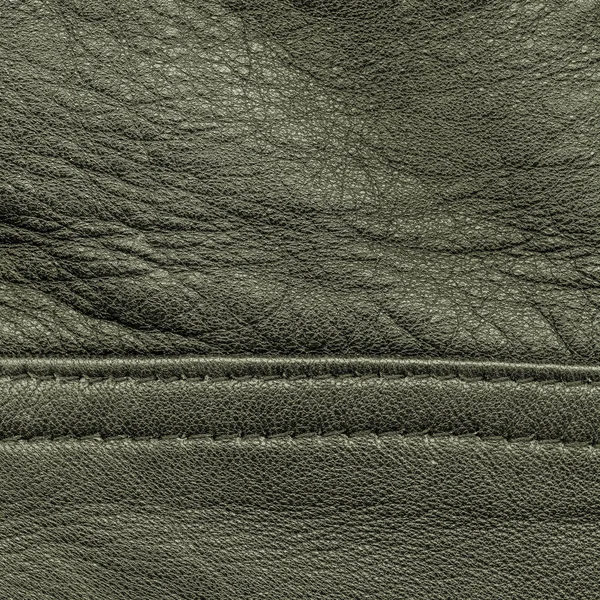 Grå-grön läder texture, söm. Användbar som bakgrund — Stockfoto