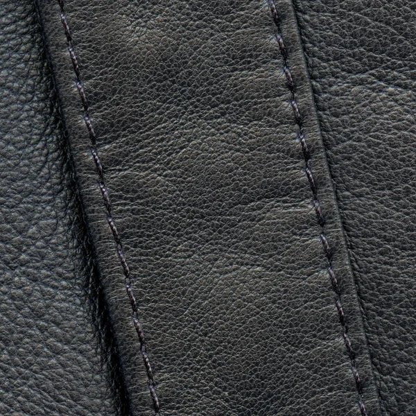 Black leather background decorated with seams,stitches — Stock Photo, Image