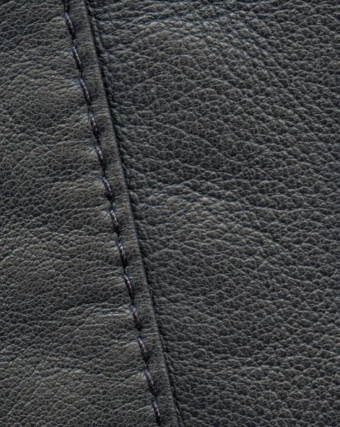 Black leather background decorated with a seam — Stock Photo, Image