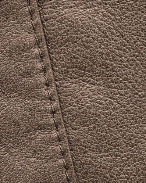 Brown leather background decorated with a seam — Stock Photo, Image