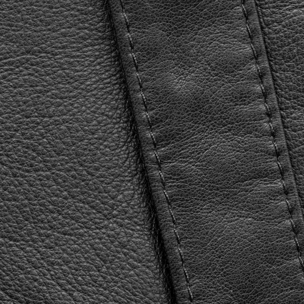 ステッチの縫い目で飾られた黒い革背景 — ストック写真