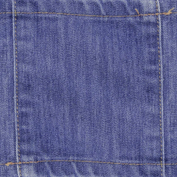 Achtergrond van blauwe denim textuur versierd met naden — Stockfoto