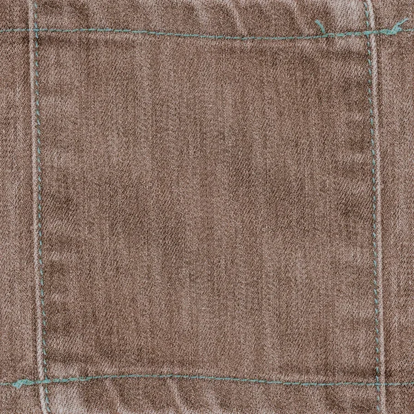 Фон коричневої джинсової текстури прикрашений швами — стокове фото
