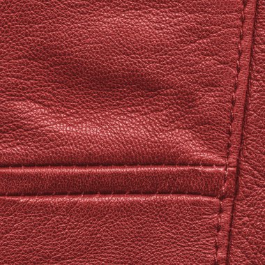 kırmızı deri arka plan dikişleri ile dekore edilmiştir. 