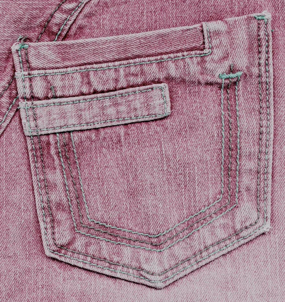 Worn red back pocket on denim background — Stock Photo, Image