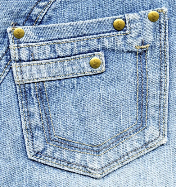 Blue denim back pocket on blue denim background — Stock Photo, Image