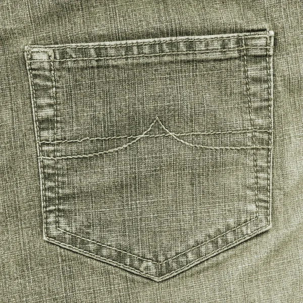 Bolso traseiro jean cinza-verde no fundo jean — Fotografia de Stock