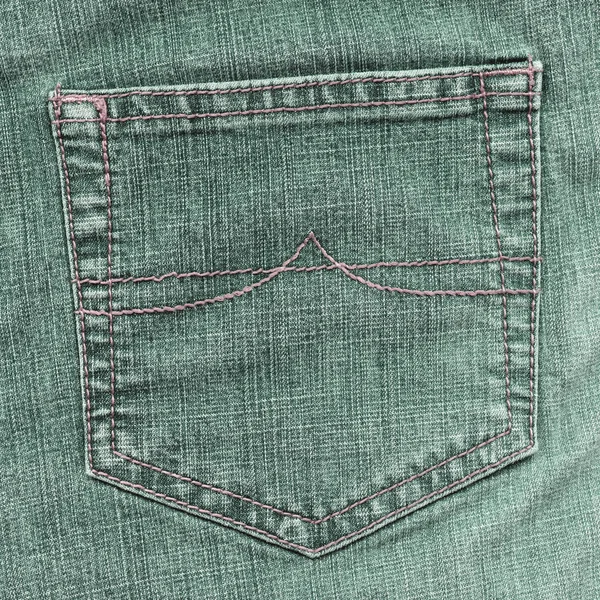 Green jean back pocket on jean background — Stock Photo, Image