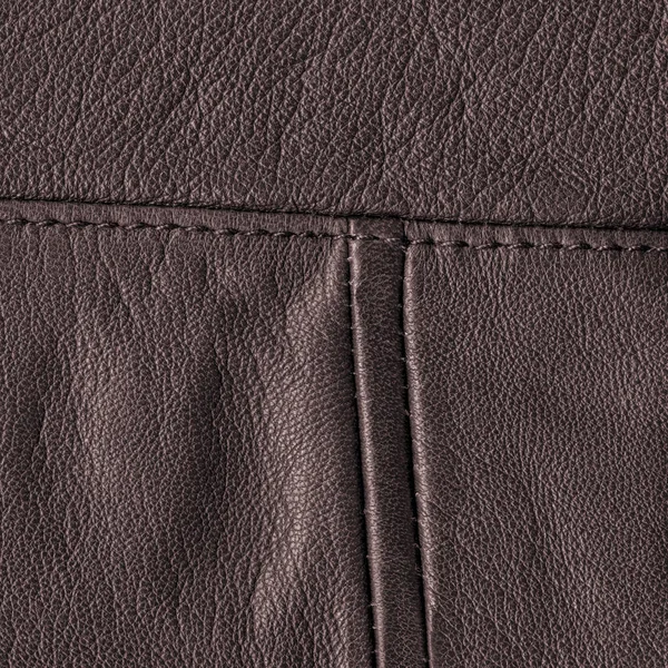 Brauner Lederhintergrund mit Nähten verziert — Stockfoto