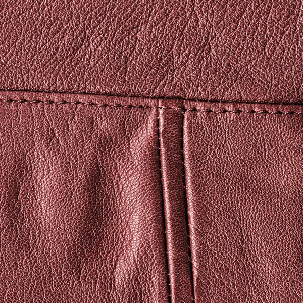 縫い目で飾られた赤い革バック グラウンド — ストック写真