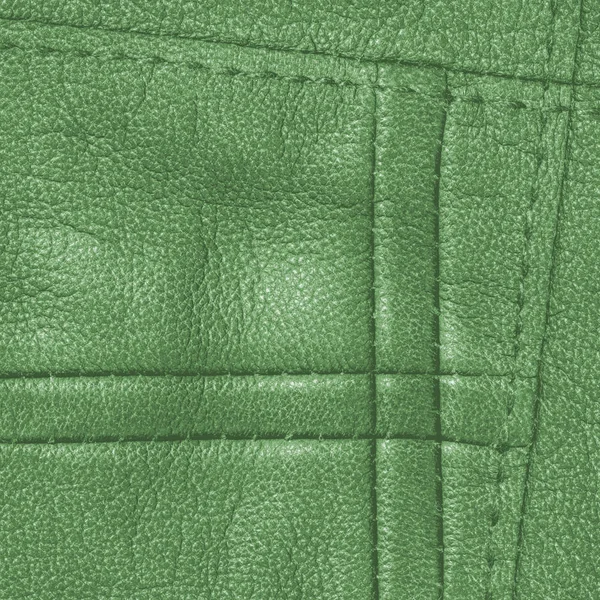 Green leather background decorated with seams — Stock Photo, Image