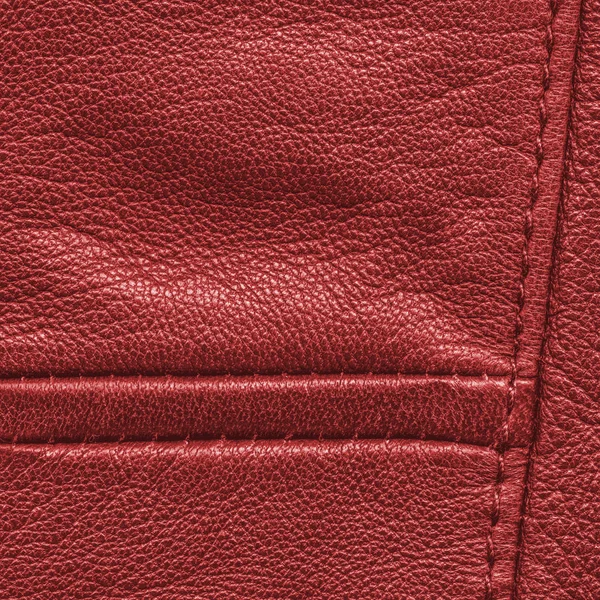 Red leather background decorated with seams — Stock Photo, Image