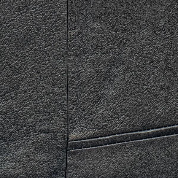Black leather background decorated with seams — Stock Photo, Image