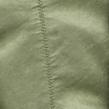 Deri arka plan dikiş ile dekore edilmiştir.