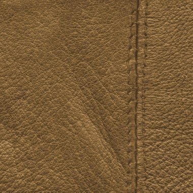 sarı-kahverengi deri arka plan bir dikiş ile dekore edilmiştir.