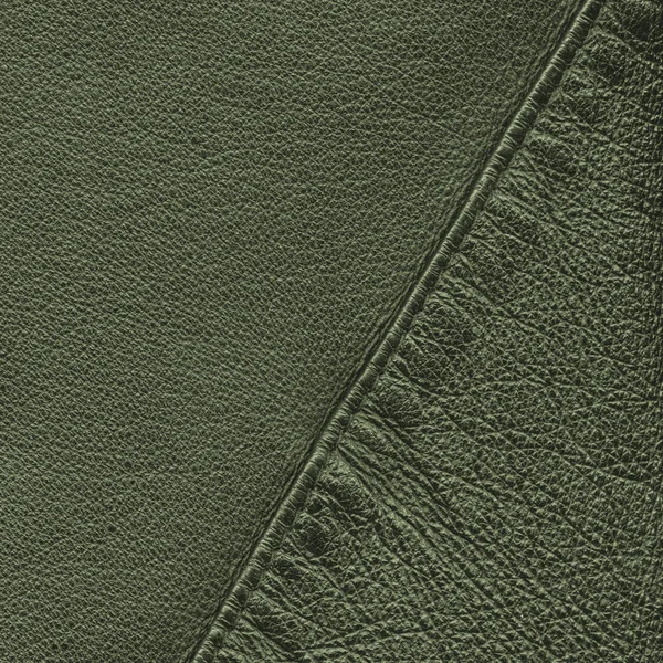 Yeşil deri arka plan bir dikiş ile dekore edilmiştir. — Stok fotoğraf