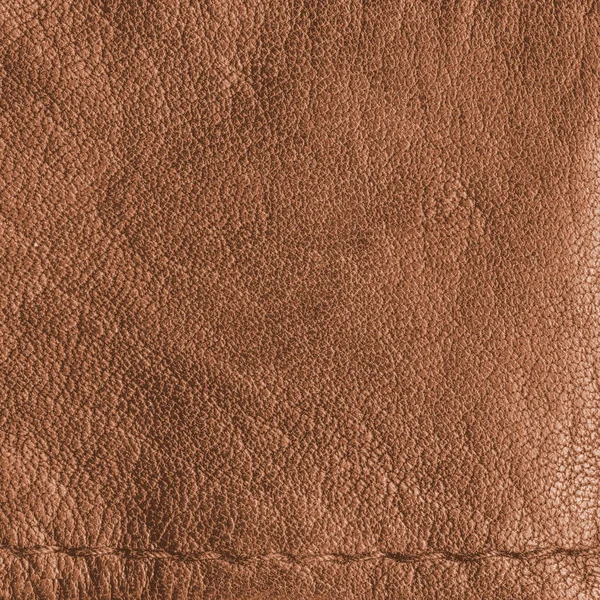 Textura de cuero amarillo-marrón como fondo, una costura — Foto de Stock