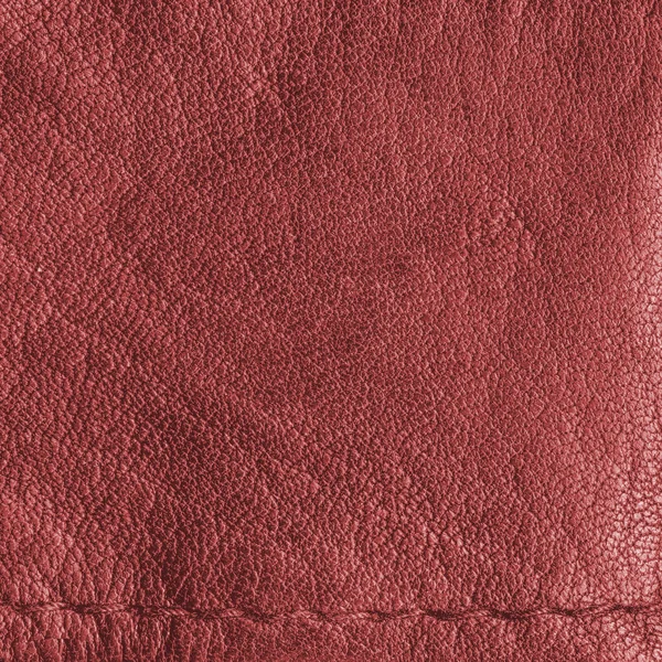 Red leather texture as background, a seam — Stock Photo, Image