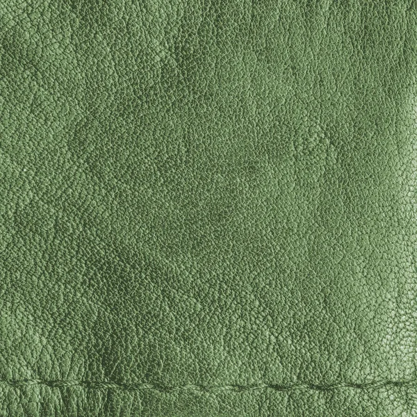 Textura de couro verde como fundo, uma costura — Fotografia de Stock