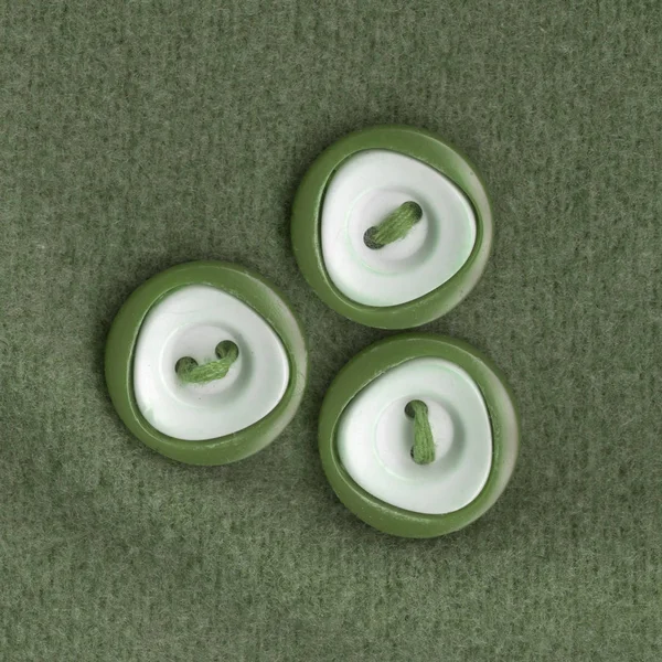 Três botões costurados ao tecido — Fotografia de Stock