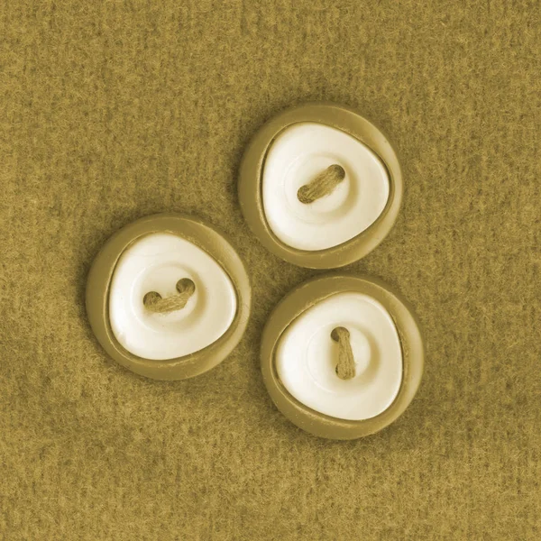Three buttons sewn to the fabric — Stock Photo, Image
