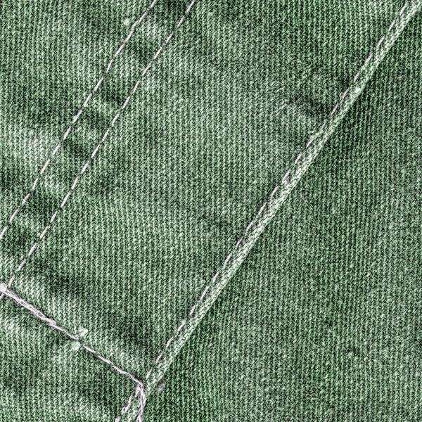 Green jean background decorated with seams — Stock Photo, Image