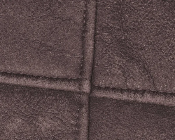 Brązowy skóry garbowanej tło z szwy — Zdjęcie stockowe