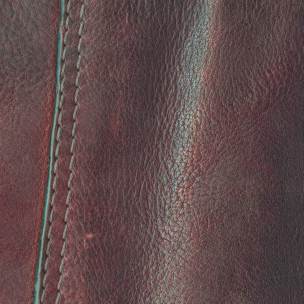 Brown leather background decorated with seam — Stock Photo, Image