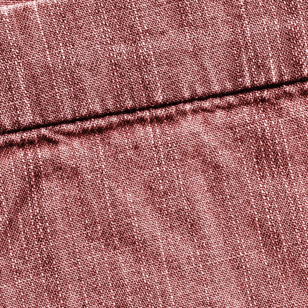 Textura de mezclilla roja, decorada con una costura . —  Fotos de Stock