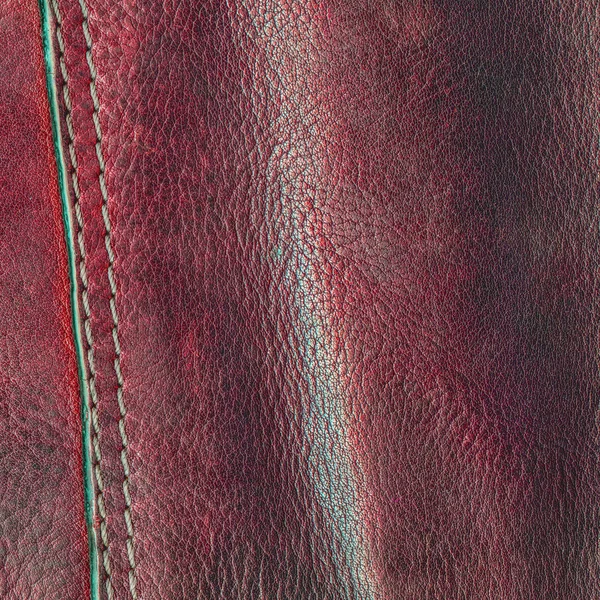 Roter Lederhintergrund mit einer Naht verziert — Stockfoto