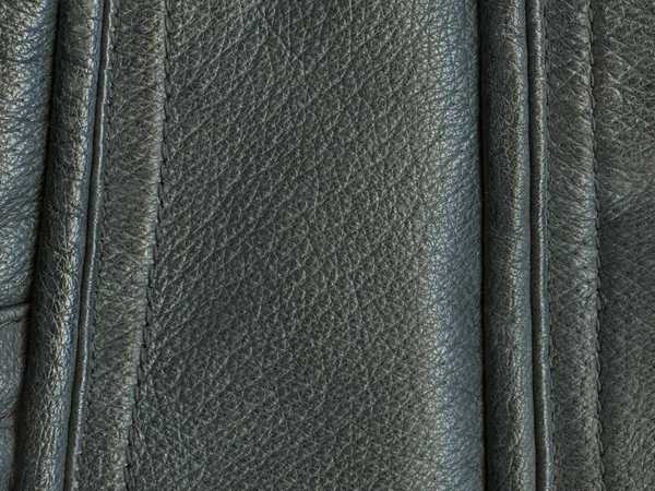 Fragment koženého kabátu jako pozadí černé kůže — Stock fotografie