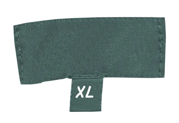 Ancienne étiquette textile verte sur blanc — Photo