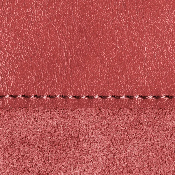 Hintergrund aus zwei zusammengenähten Stücken roten Leders — Stockfoto