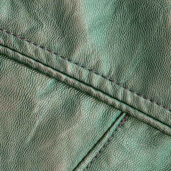 Green leather background with a seam — Stock Photo, Image