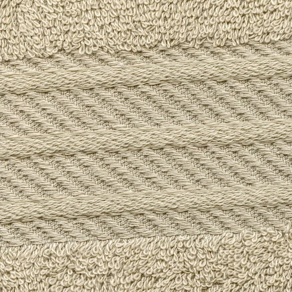 Fragment eines beigen Frotteehandtuchs als textiler Hintergrund — Stockfoto