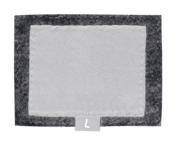 Étiquette en tissu blanc blanc blanc sur fond textile gris — Photo