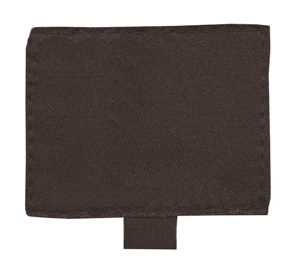 Etiqueta têxtil marrom em branco isolada no fundo branco — Fotografia de Stock