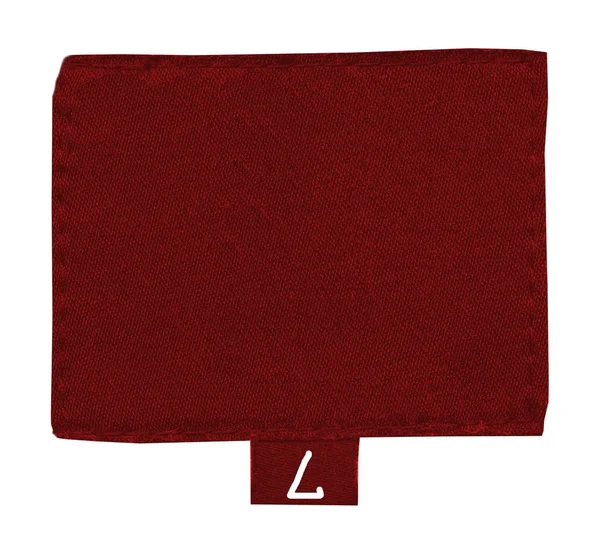 Etiqueta de tela roja en blanco sobre fondo textil gris — Foto de Stock